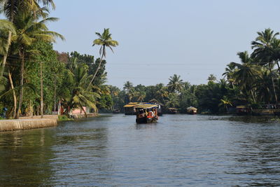 Boats in river against sky