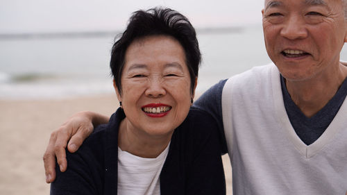 Portrait of couple standing at beach