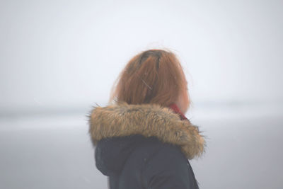 Rear view of girl against sky
