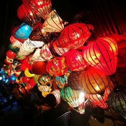 Low angle view of illuminated lanterns hanging at night