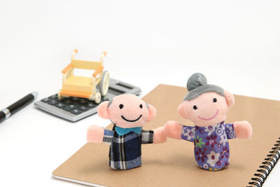 Close-up of toys on table against white background