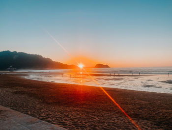 Scenic view of beach against sky during sunset