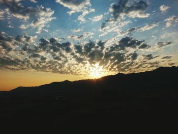 Silhouette of landscape against sunset sky