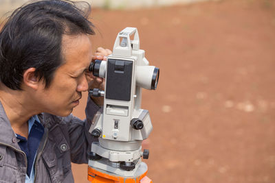 Close-up of surveyor working outdoors