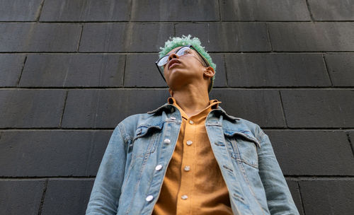 Portrait of man standing against wall