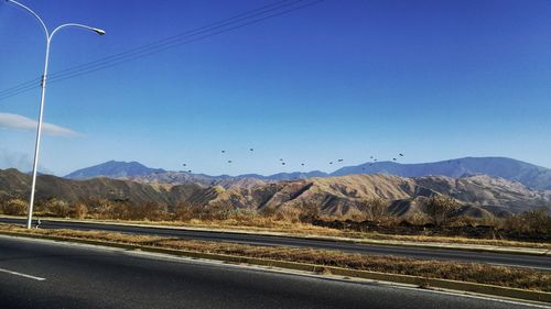 Scenic view of mountains against clear blue sky