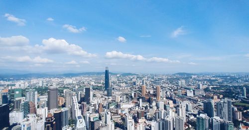 High angle view of modern buildings in city against sky