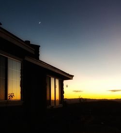 Silhouette built structure against sky at night