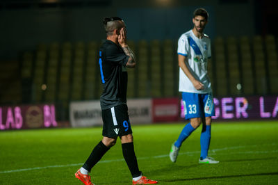 Man playing soccer on grass