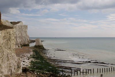 Seven sisters cliffs by sea against sky