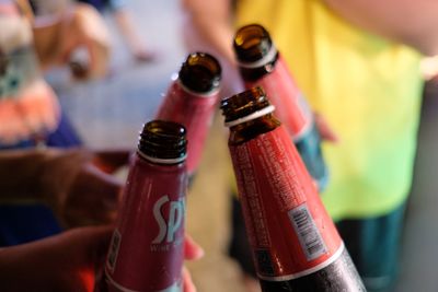 Close-up of hand holding wine bottle