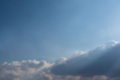 Sunbeam of the sun behind the clouds, sky background