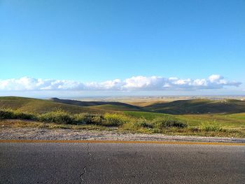 Scenic view of landscape against blue sky