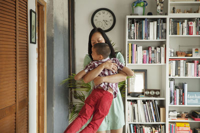 Portrait of woman standing against wall