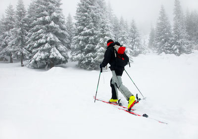 Man skiing on snow covered field