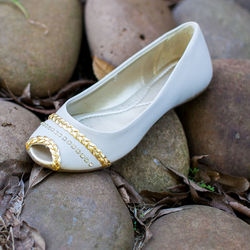 Low section of white shoes on rock