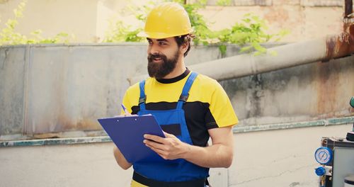 Portrait of young man working at construction site