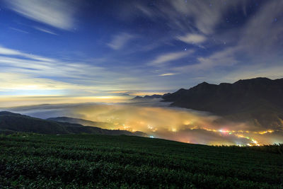 Scenic view of field against sky at night