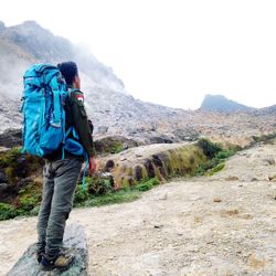 Rear view of man walking on mountain