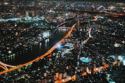 High angle view of city lit up at night