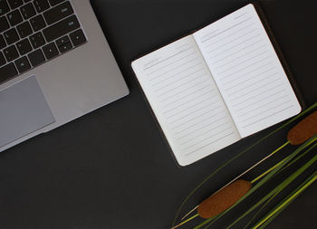 High angle view of laptop and book on table