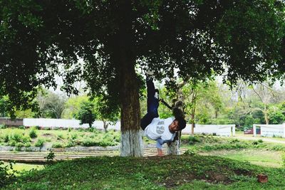 Man standing on bench in park