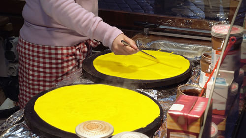 Midsection of person preparing food