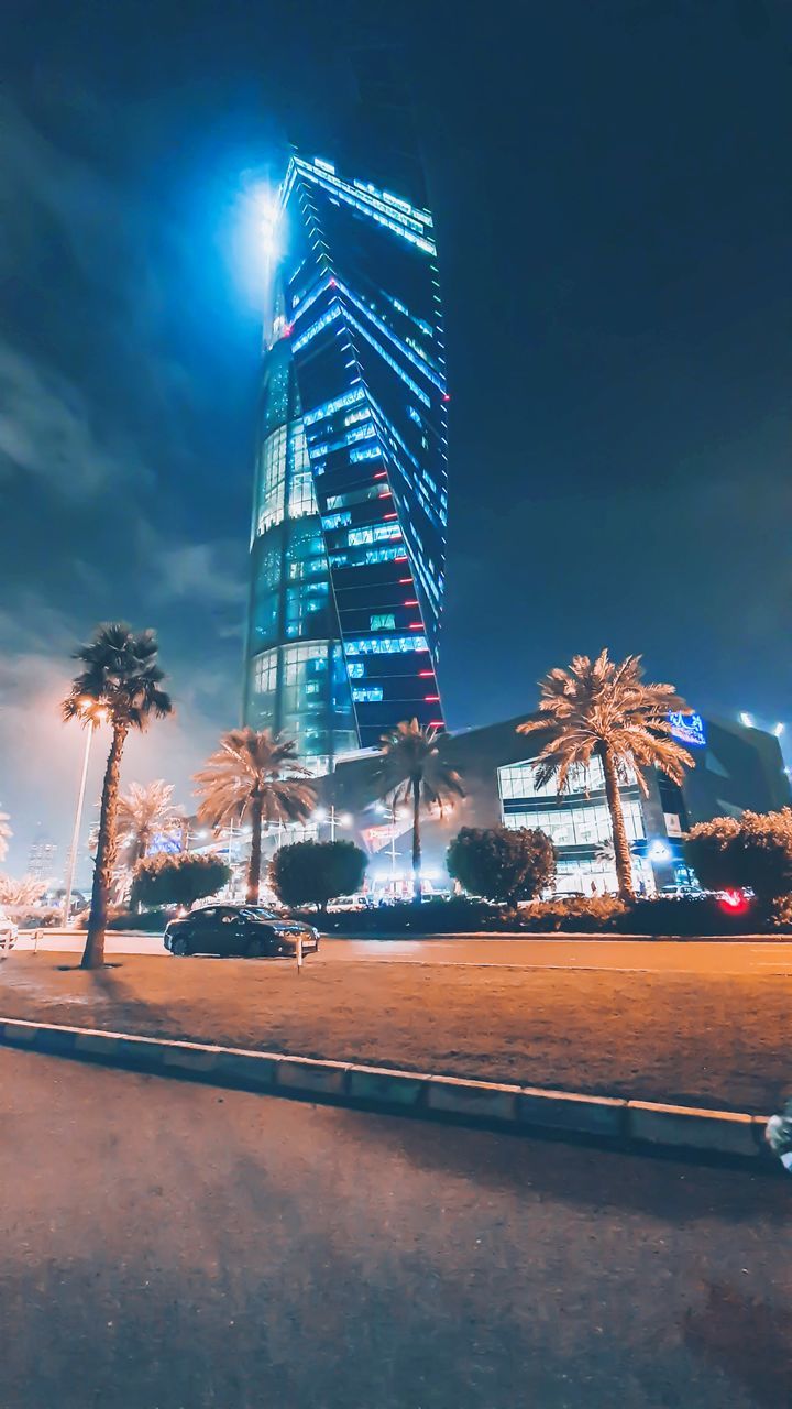 illuminated, night, built structure, city, building exterior, sky, architecture, tree, nature, street, office building exterior, no people, tall - high, travel destinations, long exposure, motion, building, plant, skyscraper, transportation, outdoors, modern