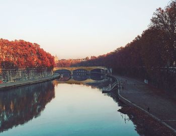 Scenic view of river against clear sky during autumn