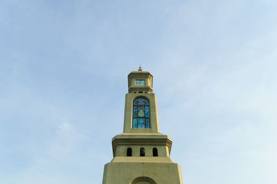 Low angle view of clock tower and building against sky