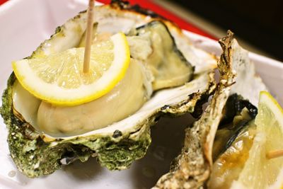 Close-up of oyster with lemon slice on table