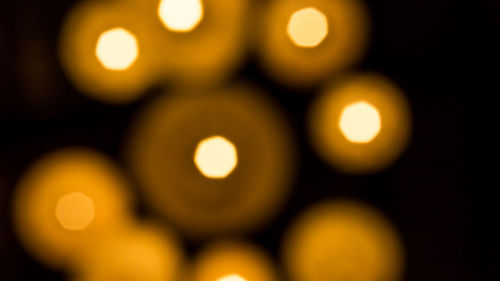 Close-up of illuminated yellow lights at night