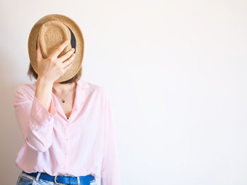 Young woman wearing mask against white background