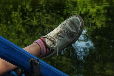 Low section of woman standing on railing