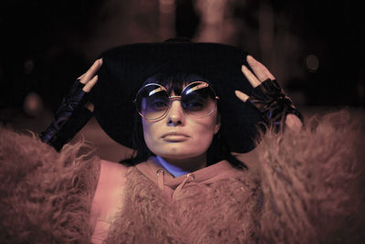 Close-up of woman wearing hat and sunglasses