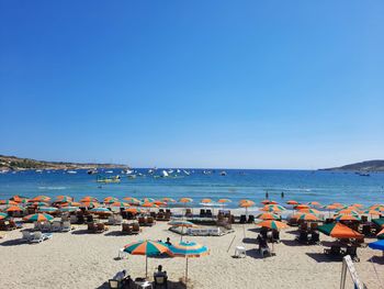 Panoramic view of beach against clear blue sky