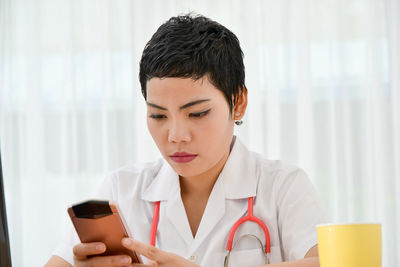 Close-up of doctor using mobile phone