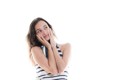 Portrait of beautiful young woman against white background