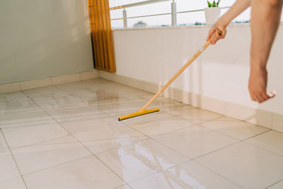 Man wiping floor with the mop.  washing the dirty floors.  mopping the balcony  cleaning equipment 