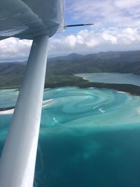 Aerial view of sea and mountains against sky
