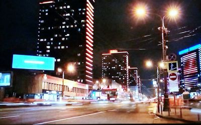 Illuminated city street at night