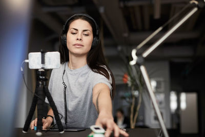 Creative businesswoman looking at solar toy car at desk in office