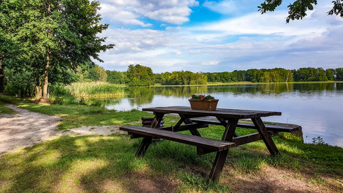 Gazebo on table by lake against sky