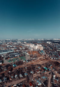 High angle view of city buildings against clear blue sky