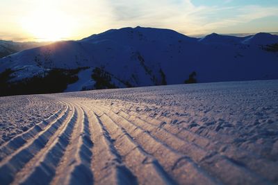 Scenic view of snow mountains against sky during sunset