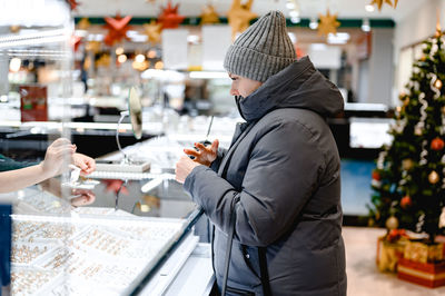 Rear view of woman drinking wine in temple