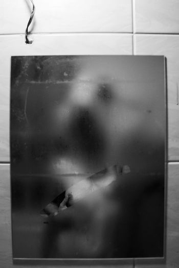 REFLECTION OF WOMAN IN GLASS