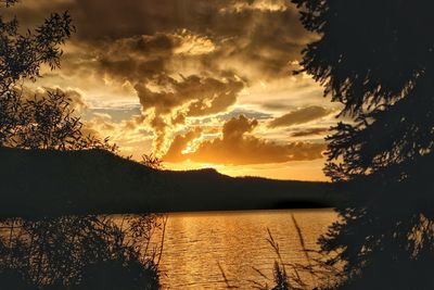 Scenic view of lake against sky during sunset