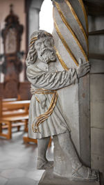 Close-up of angel statue against temple