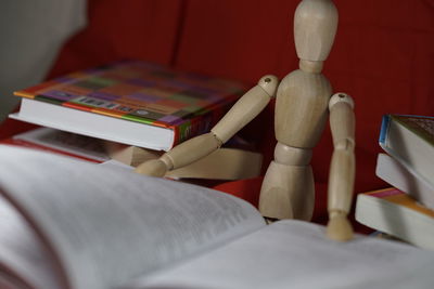 Wooden figurine with open book